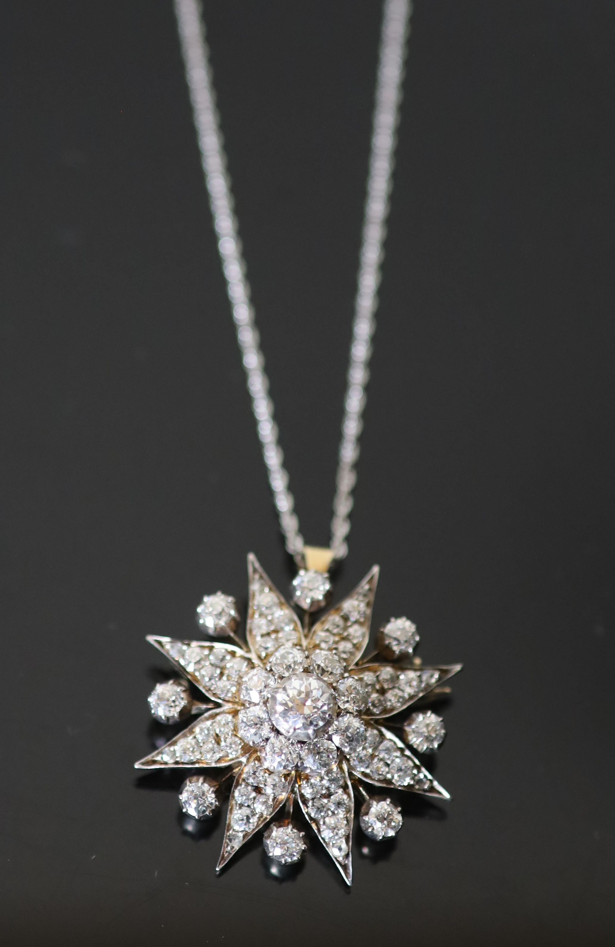 A Victorian, gold, silver and diamond cluster set star pendant brooch,